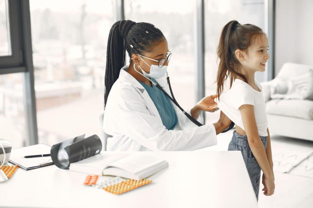 the doctor checks the patient kid