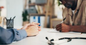 Patient reviewing and signing healthcare testimonial consent for ethical marketing use